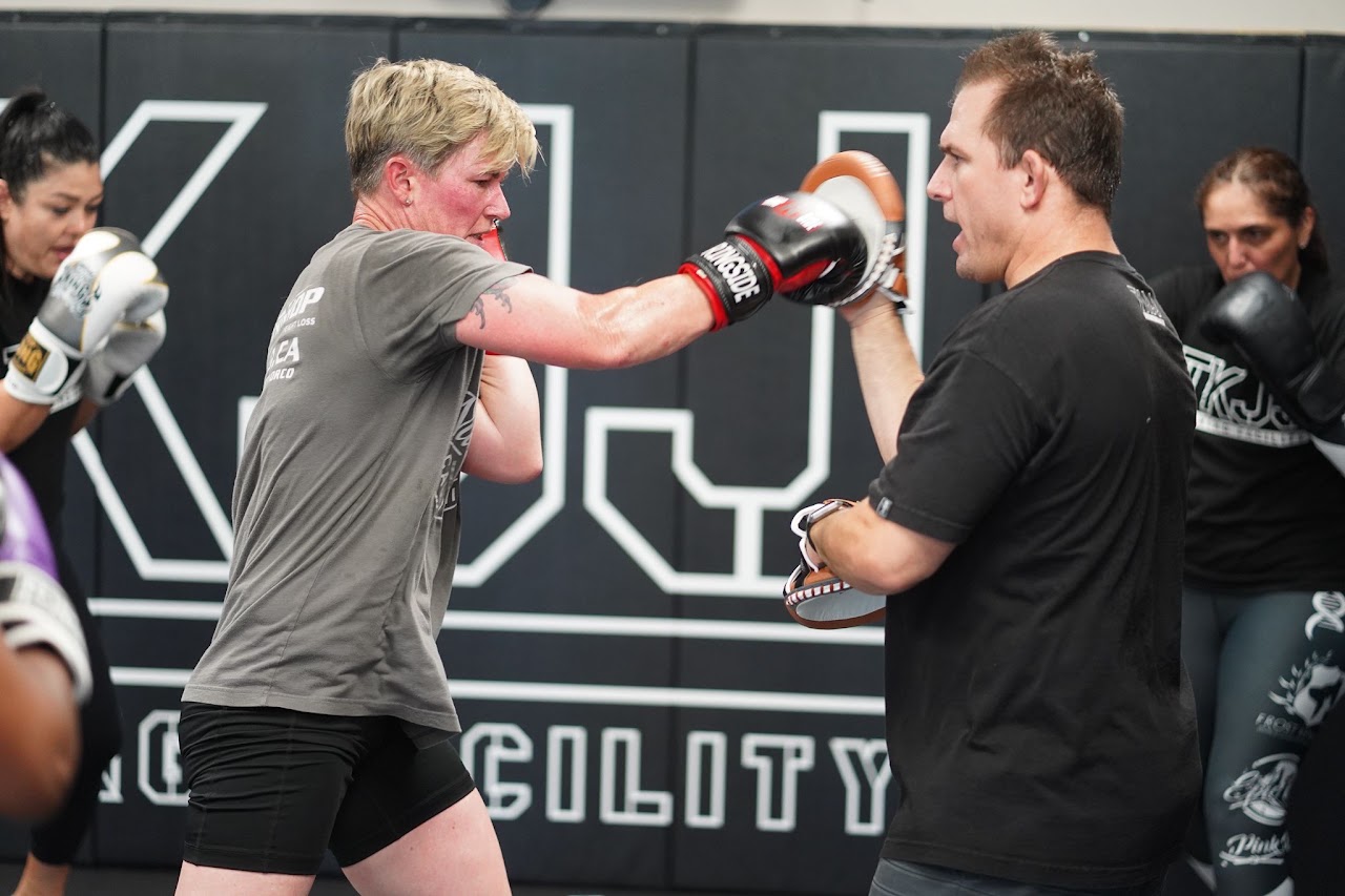 A student and coach working on boxing technique at TKJJ Training Facility